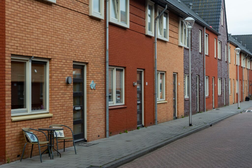 A picturesque view of a suburban street lined with colorful row houses exhibiting a unique architectural charm.